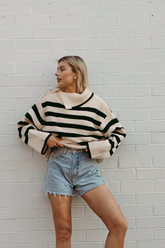 a lady wears a striped sweater with denim shorts